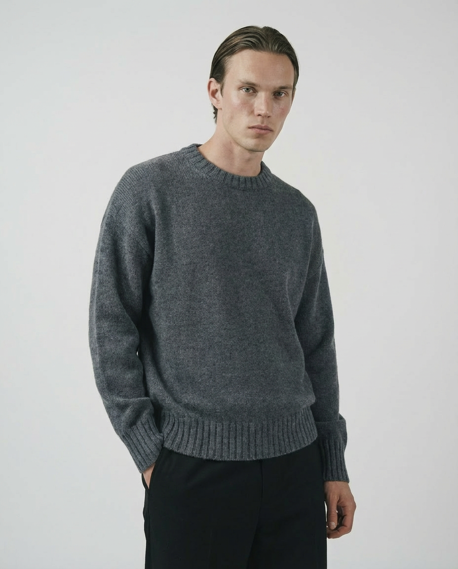 man wearing a dark gray charcoal crewneck sweater made in italy casa nodale merino wool and cashmere
