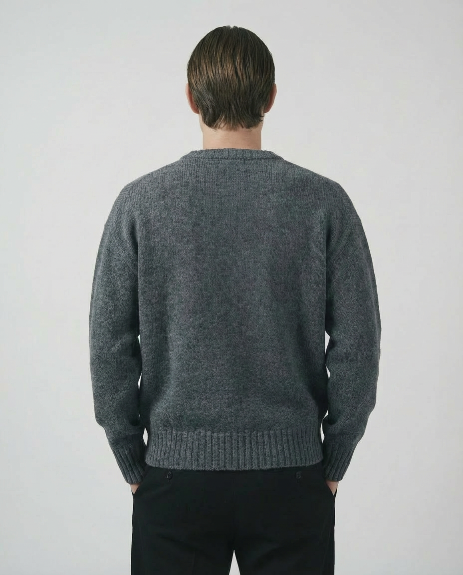 man wearing a dark gray charcoal crewneck sweater made in italy casa nodale merino wool and cashmere