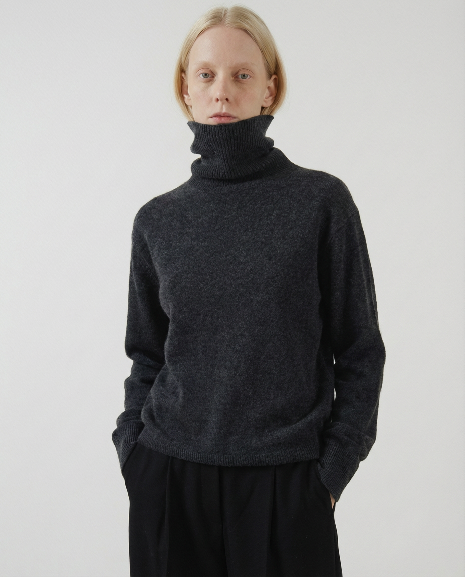 woman wearing a dark gray charcoal turtleneck sweater made in italy casa nodale merino wool and cashmere
